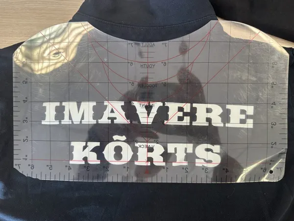Trükk paigutusmalli all rõiva seljal, enne pressimist